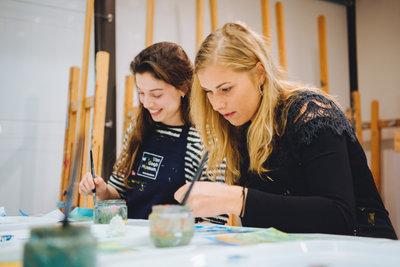 Two young women are painting in the workshop studio at the Van Gogh Museum. Photo: Jelle Draper