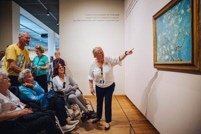 Senior citizens are looking at Van Gogh's painting Almond Blossom during a guided tour in the Van Gogh Museum. Photo: Jelle Draper