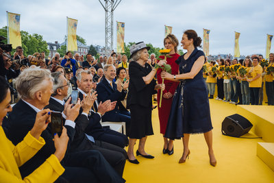 Emilie Gordenker, Director of the Van Gogh Museum, presents Princess Beatrix with a sunflower. Photograph: Jelle Draper