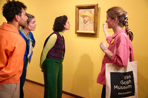 A group of visitors look at a self-portrait by Vincent van Gogh during a guided tour at the Van Gogh Museum. Photo: Suzanne Karsters