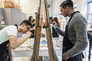 Two young men are painting in the Van Gogh Museum workshop studio. Photo: Jaasir Linger